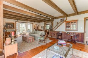 Living room with fieldstone fireplace - Country homes for sale and luxury real estate including horse farms and property in the Caledon and King City areas near Toronto